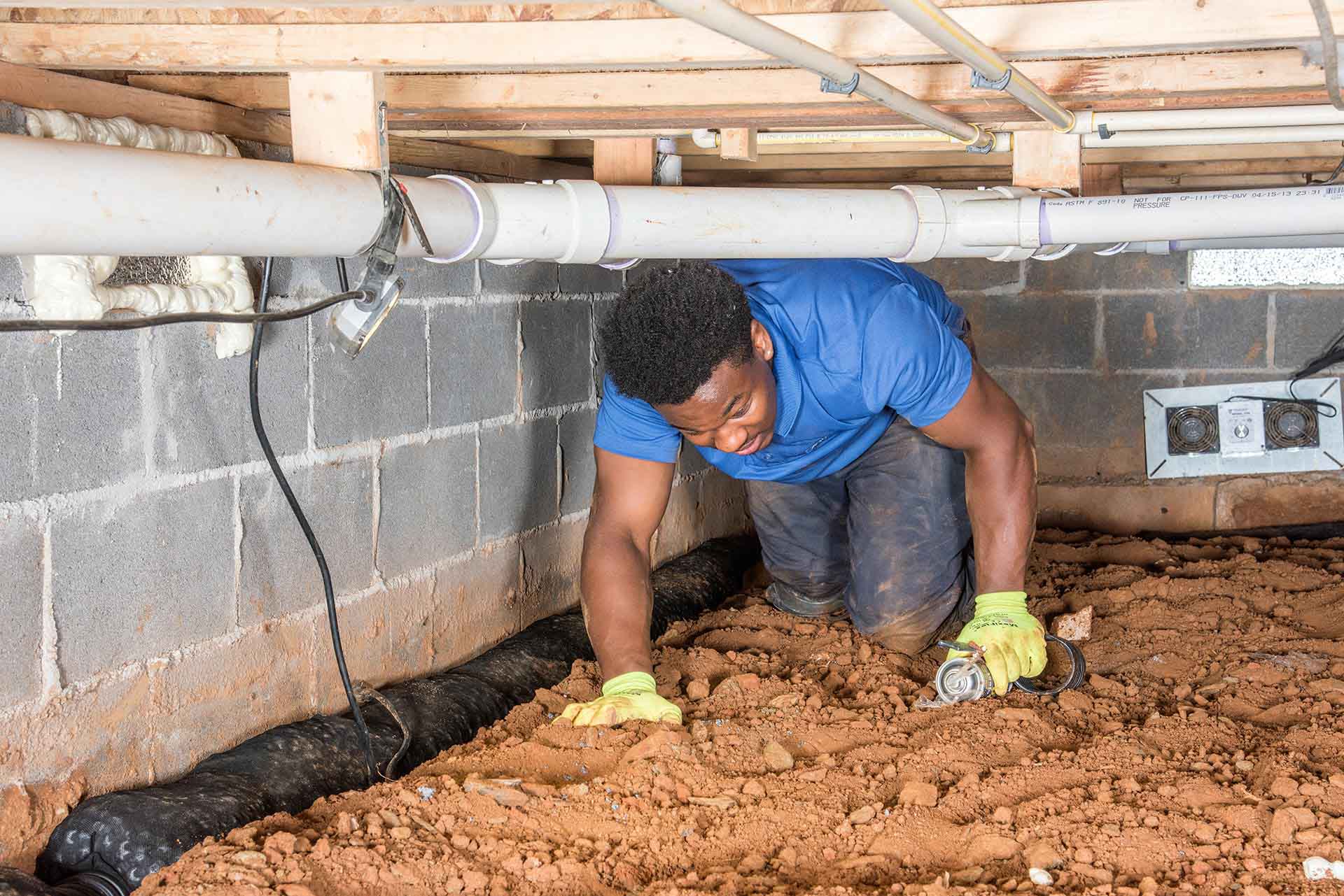 crawl space with engineer working on repairs