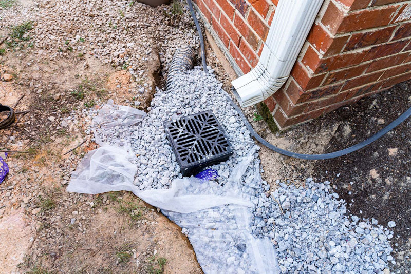 An open system catch basin includes a grate at the ground level that allows water and debris to flow freely into the chamber below. As you might have guessed, these systems get their name from the fact that they are open to the air above.