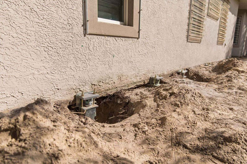 Underpinning involves inserting piers into the earth and attaching them to the foundation. Once the connection is in place, your repair team can use the piers to raise the foundation and hold it in place to prevent future settlement.